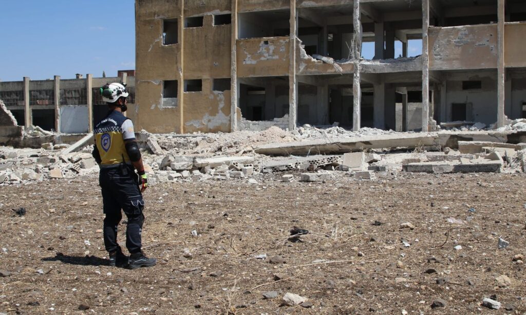 A Syria Civil Defence member inspects a school in Jisr al-Shughour, rural Idlib after it was targeted by Russian shelling - July 11, 2024 (Syria Civil Defence)