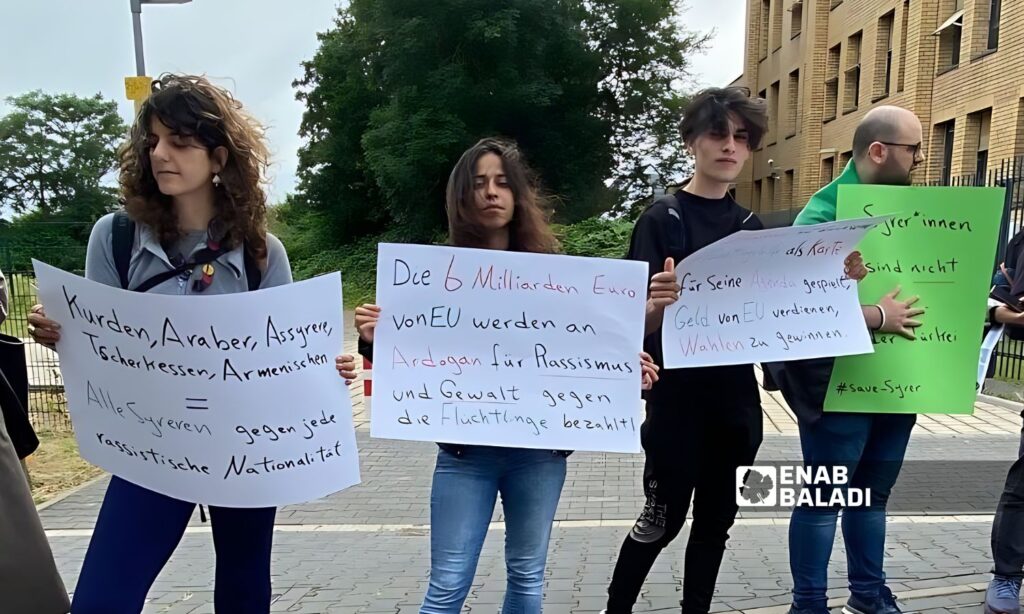 The refugees raised signs in both English and German demanding the Turkish government to protect refugees from racist attacks - July 7, 2024 (Enab Baladi)