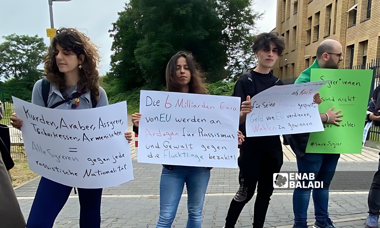 The refugees raised signs in both English and German demanding the Turkish government to protect refugees from racist attacks - July 7, 2024 (Enab Baladi)
