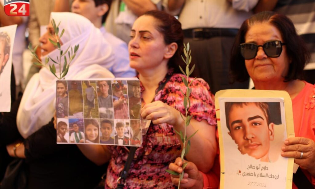 Banners and pictures raised by the protesters in al-Karamah Square in the center of As-Suwayda, condemning the Majdal Shams attack – August 2, 2024 (Suwayda 24)