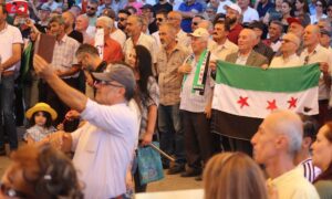 Protesters in As-Suwayda raise the flag of the Syrian revolution, confirming the continuation of their peaceful movement - August 9, 2024 (Suwayda 24)