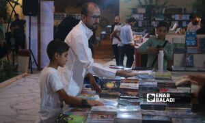 Visitors at the Idlib Book exhibition in the city of Idlib, northwestern Syria - August 2, 2023 (Enab Baladi/Anas al-Khouli)