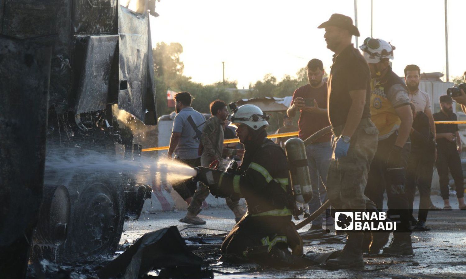 A member of the Syria Civil Defence extinguishes the fire in a truck after a truck explosion in Azaz - August 7, 2024 (Enab Baladi/Dayan Junpaz)