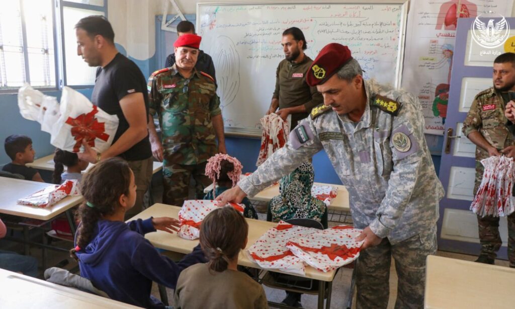 Hassan al-Hamada, Minister of Defense in the Syrian Interim Government (SIG), distributes stationary kits to students in rural Aleppo - November 1, 2023 (Ministry of Defense)