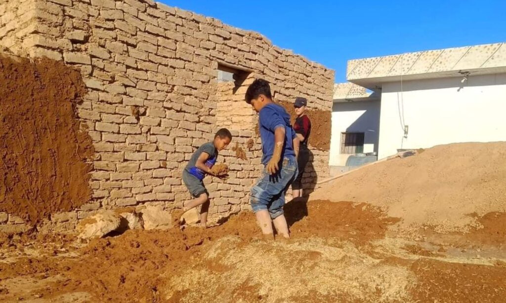 Young men working in clay brick construction in the town of Al-Izbah in the northern countryside of Deir Ezzor - September 30, 2024 (Enab Baladi/Obadah al-Sheikh)