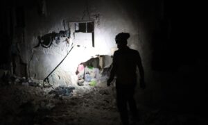 A member of the Syria Civil Defence inspects a site targeted by regime forces in Darat Izza, Aleppo countryside - October 6, 2024 (Syria Civil Defence)