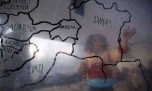 A refugee child looks at a map of Europe inside a makeshift tent at a refugee camp near the registration center on the Greek island of Lesbos - March 23, 2016 (Reuters)
