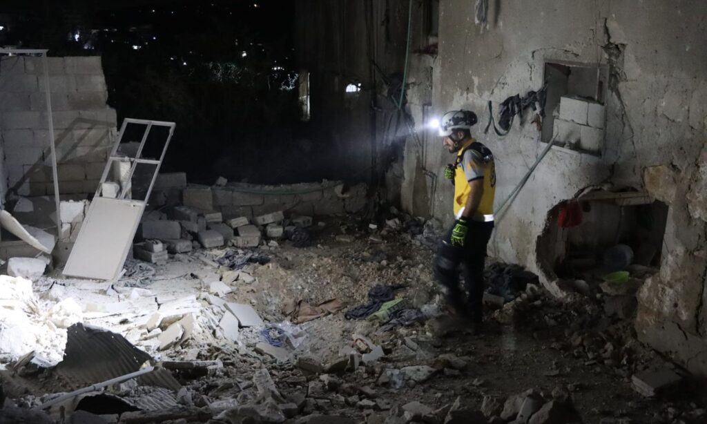 A Syria Civil Defence member inspects a site targeted by regime forces in Darat Izza, Aleppo countryside - October 6, 2024 (Syria Civil Defence)