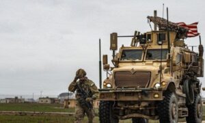 An International Coalition armored vehicle in the Conoco field in Deir Ezzor countryside - May 22, 2023 (Reuters)
