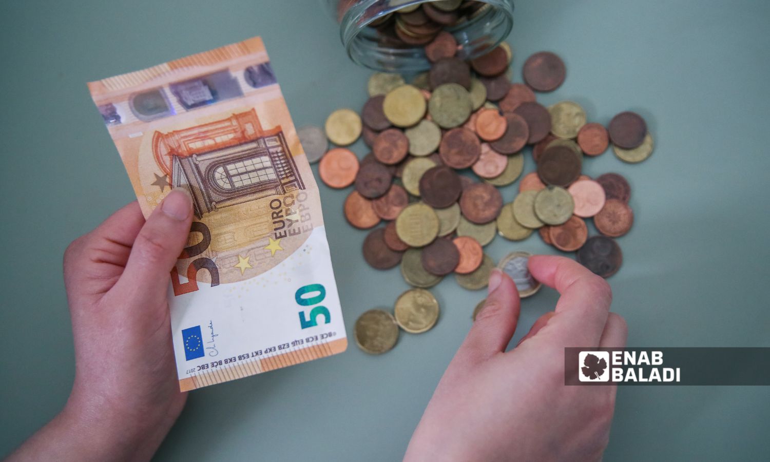 Coins and a banknote of 50 euros (Enab Baladi)