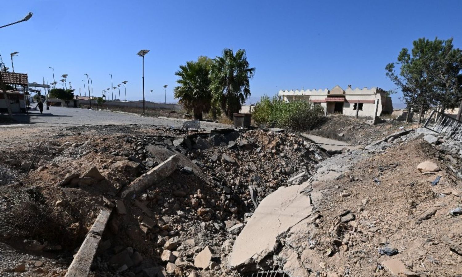 A crater created by an airstrike carried out by an Israeli warplane on the Jousiyeh border crossing between Syria and Lebanon near the military security outpost - October 29, 2024 (AFP/Louai Beshara)