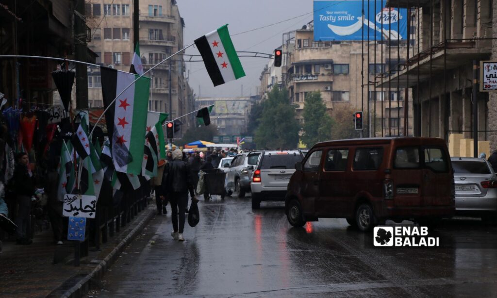 The spread of the Syrian revolution flags in the shops of Aleppo streets - December 15, 2024 (Enab Baladi/Walid al-Idlibi)