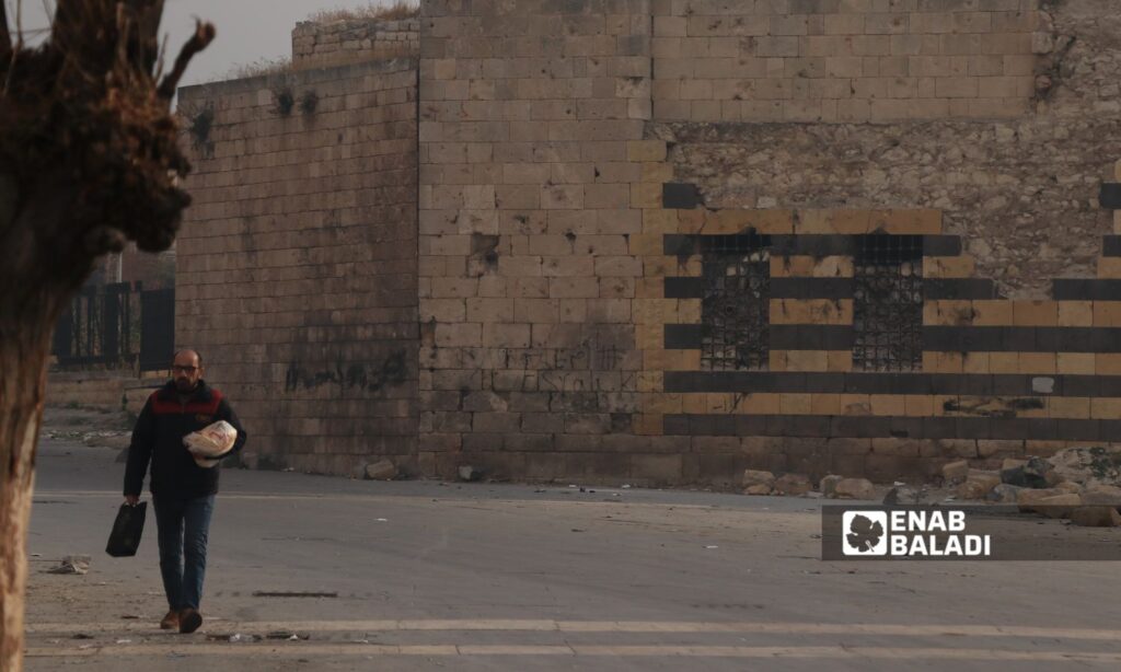 A man walks on the Aleppo Citadel street in the city of Aleppo - December 12, 2024 (Enab Baladi/Walid al-Idlibi)