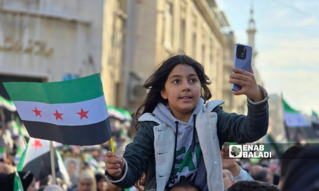 A child in the city of Hama during the celebration of the regime's fall - December 13, 2024 (Enab Baladi/Iyad Abdul Jawad)