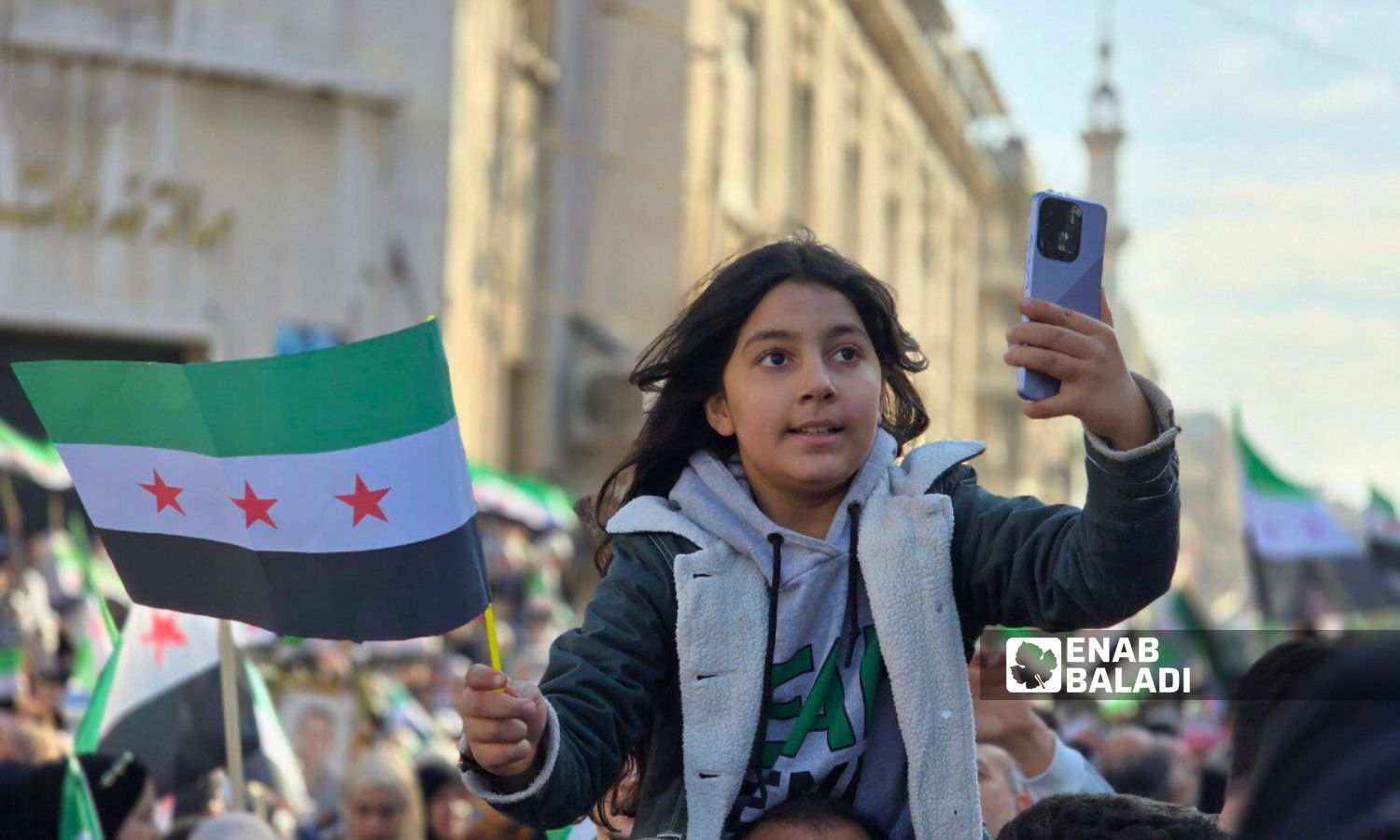 A child in the city of Hama during the celebration of the regime