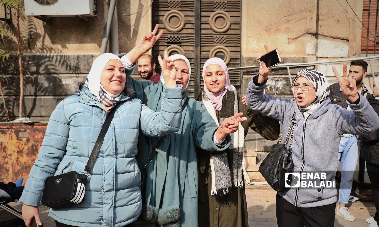 Girls celebrating the fall of the Syrian regime in the streets of Homs - December 9, 2024 (Enab Baladi/Walid al-Idlibi)