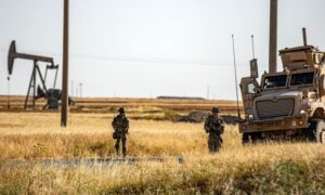 US forces patrol near an oil well in al-Qahtaniya in al-Hasakah province in northeastern Syria, near the border with Turkey - June 14, 2023 (AFP/Delil Souleiman)