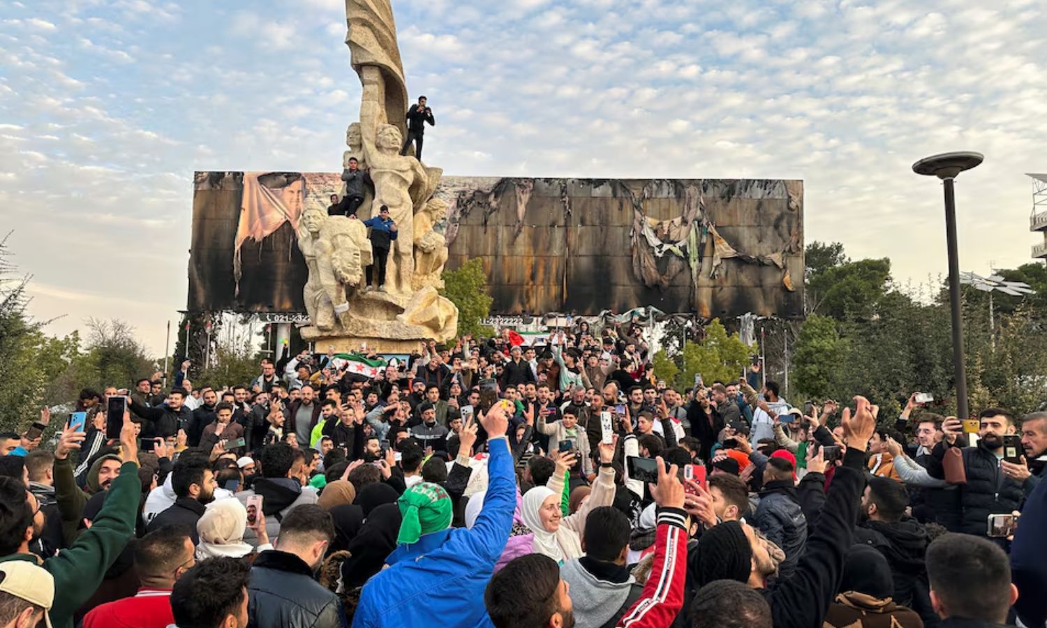 Syrians celebrate in Saadallah Jabri Square in Aleppo after the fall of Bashar al-Assad's regime - December 8, 2024 (Reuters)