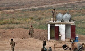 Members of the Syrian Democratic Forces at the Syrian side of the al-Yarubiya border crossing with Iraq - October 16, 2023 (AP)