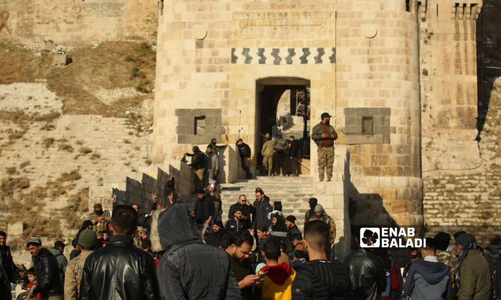 Opposition fighters in front of Aleppo Citadel after taking control of it - November 30, 2024 (Enab Baladi/Dayan Junpaz)