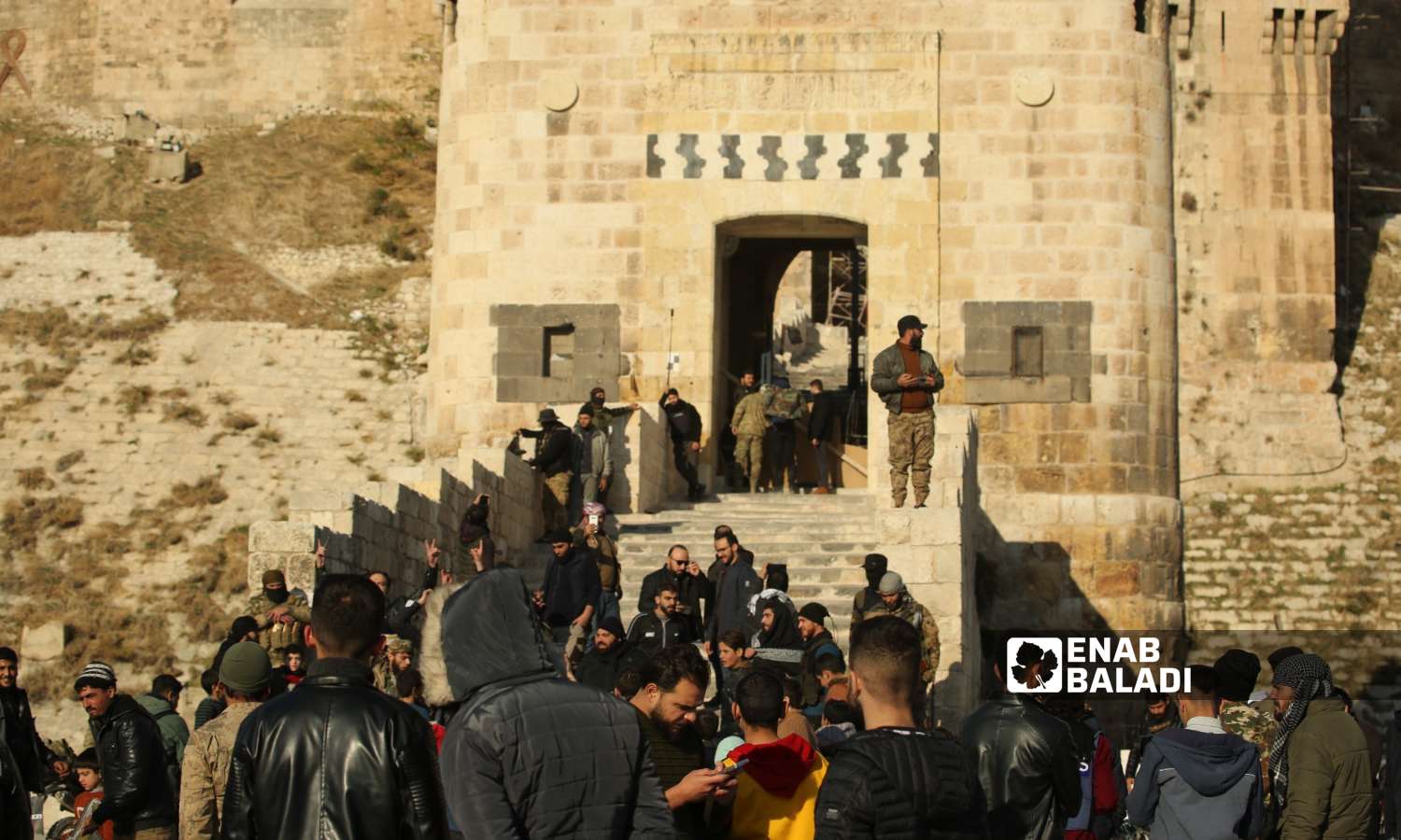 Opposition fighters in front of Aleppo Citadel after taking control of it - November 30, 2024 (Enab Baladi/Dayan Junpaz)
