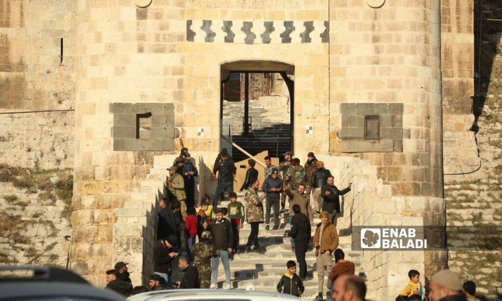 Opposition fighters and civilians in front of Aleppo Citadel after taking control - November 30, 2024 (Enab Baladi/Dayan Junpaz)