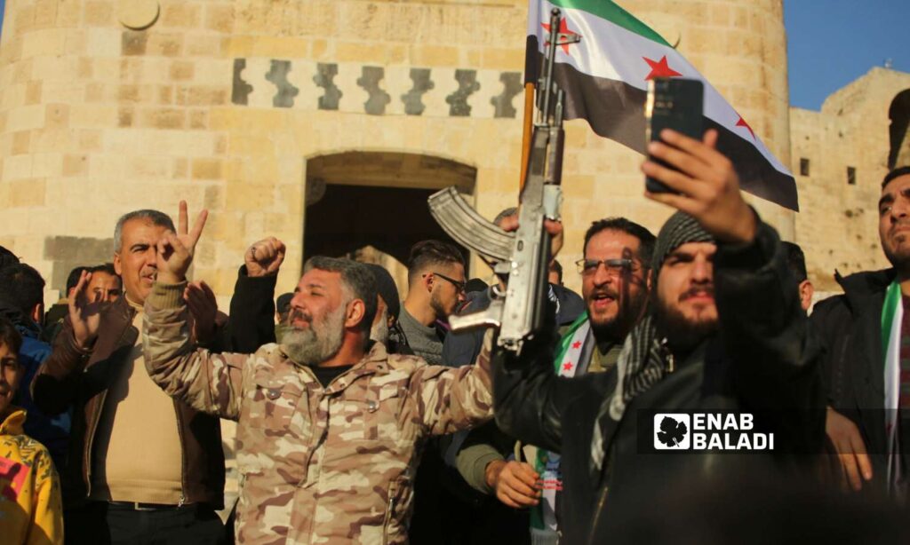 Opposition fighters in front of Aleppo Citadel after taking control of it - November 30, 2024 (Enab Baladi/Dayan Junpaz)