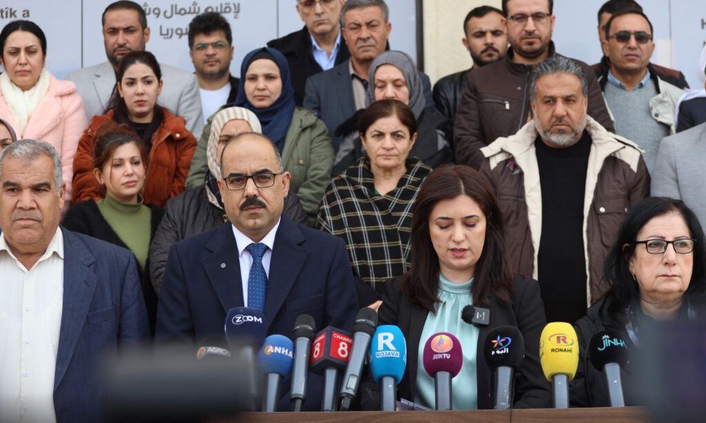 The joint presidency and members of the Autonomous Administration of North and East Syria (AANES) during a press conference statement - December 8, 2024 (AANES)