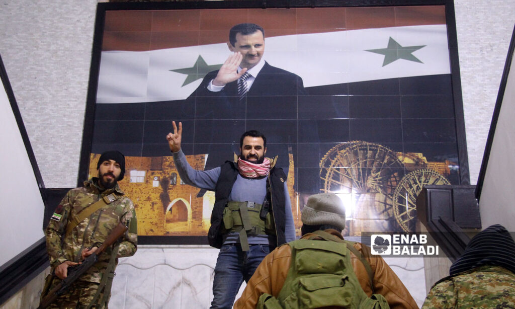 Fighters of the opposition factions inside the Governorate Building in the city of Hama - December 5, 2024 (Enab Baladi/Iyad Abdul Jawad)