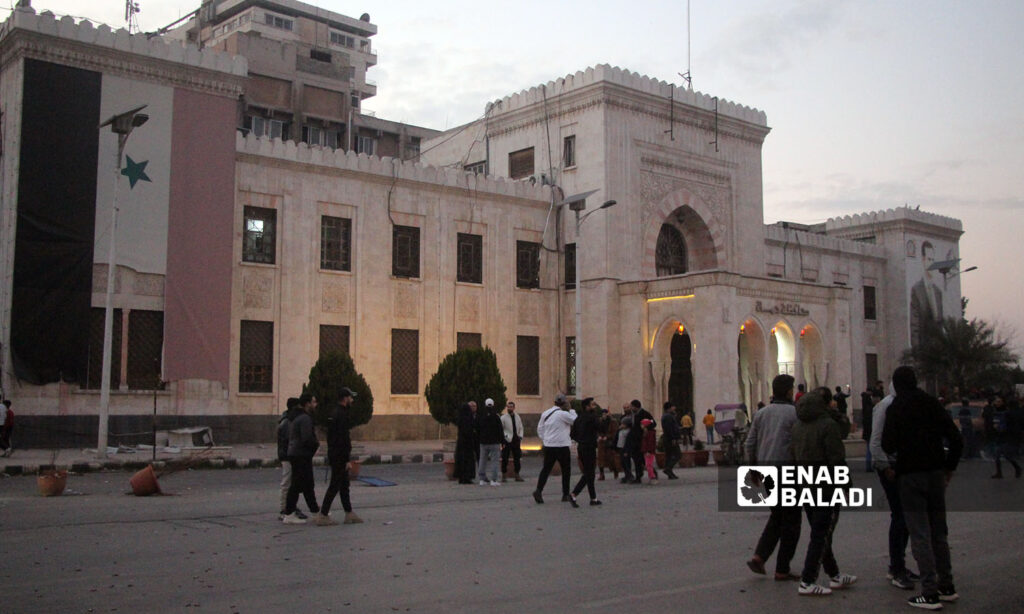 Residents of Hama city and fighters from the opposition factions in front of the Governorate Building - December 5, 2024 (Enab Baladi/Iyad Abdul Jawad)