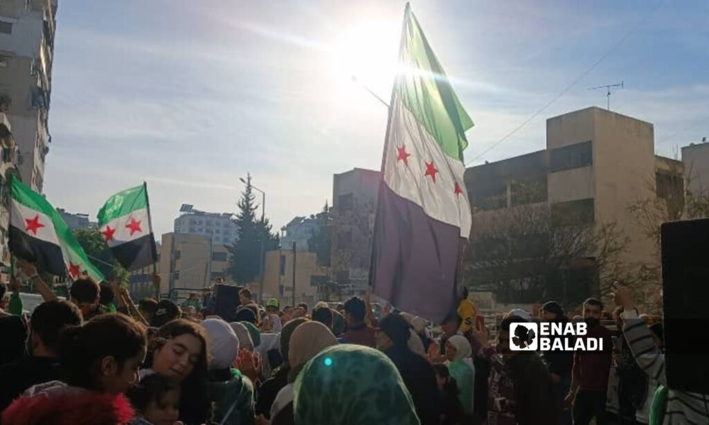 Demonstrators raised the flag of the Syrian revolution in celebration of Bashar al-Assad's fall - December 10, 2024 (Enab Baladi)