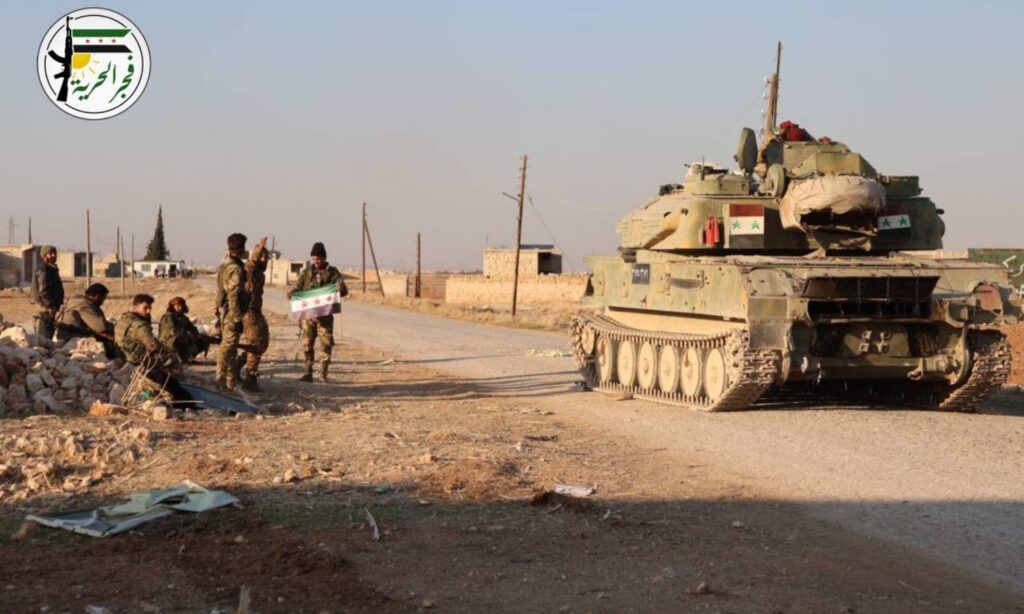 Members of the Syrian National Army near a tank they seized from regime forces during the "Dawn of Freedom" operation - November 30, 2024 (Dawn of Freedom/Telegram)