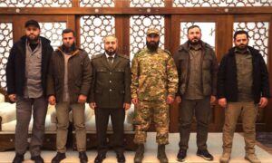 The new Syrian Defense Minister, Murhaf Abu Qasra, is flanked by leaders of opposition military factions following organizational sessions held to start the integration of the factions into the Ministry of Defense - January 11, 2025 (SANA)