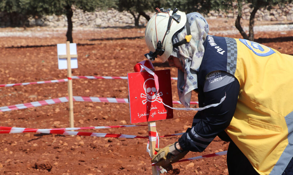 A volunteer in the Syria Civil Defence participates in the destruction of unexploded ordnance in Idlib countryside - August 22, 2024 (Syria Civil Defence)