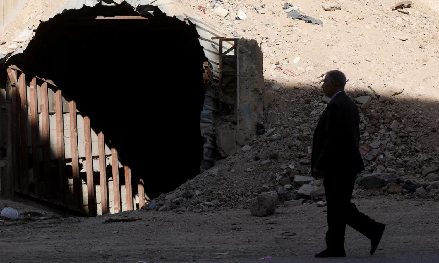 A man walks in front of a shelter that residents used to protect themselves from attacks in Douma after the fall of Bashar al-Assad - December 14, 2024 (Reuters/Yamam al-Shaar)