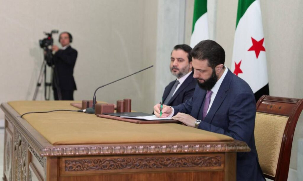 Interim Syrian President Ahmed al-Sharaa signs the draft constitutional declaration - March 13, 2025 (Syrian Presidency)