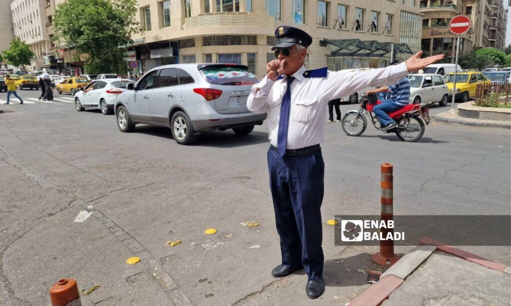 Policeman Mohammed Shahwan during his work in the Victoria Bridge area of Damascus - April 30, 2025 (Enab Baladi/Christina al-Shammas)