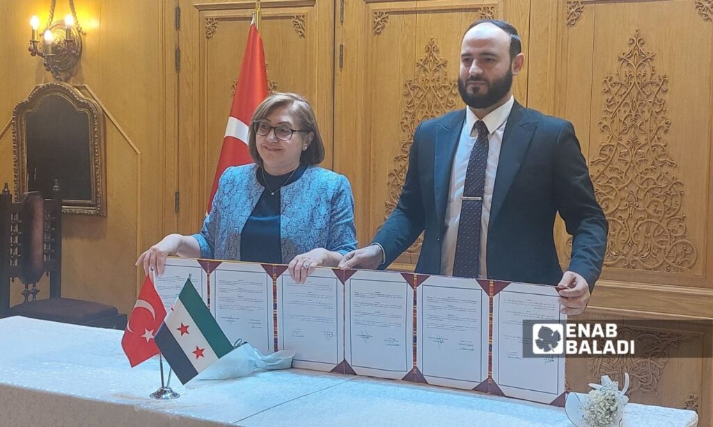 Aleppo Governor Azzam al-Gharib signs a twinning agreement with Gaziantep Mayor Fatma Şahin - May 29, 2025 (Enab Baladi/Mohammad Deeb Bazt)