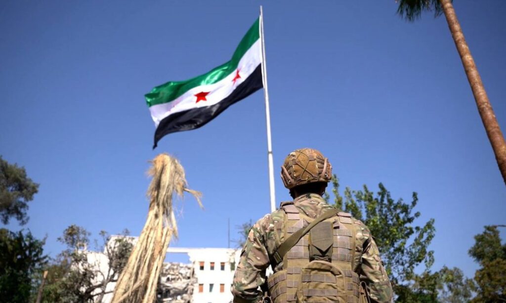 The Ministry of Defense reinstates the Syrian flag in front of the General Staff building destroyed in an Israeli airstrike – July 21, 2025 (Ministry of Defense/X)
