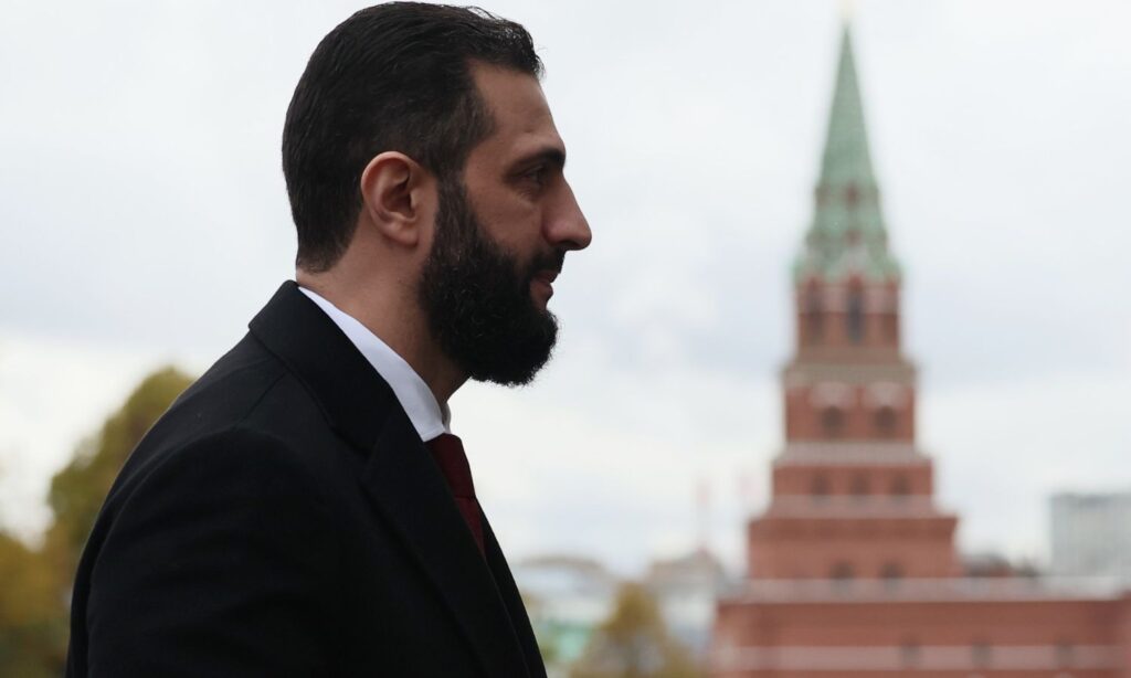 Syria’s transitional president Ahmed al-Sharaa stands in front of the Kremlin in Moscow, October 15, 2025 (TASS)