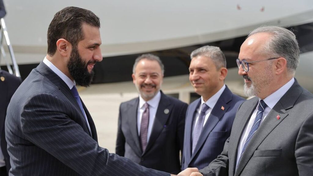 Transitional Syrian President Ahmed al-Sharaa shakes hands with Turkish Deputy Foreign Minister Nuh Yilmaz during the Syrian president’s visit to Turkey to attend the Antalya Diplomacy Forum, 11 April 2025 (Anadolu Agency).
