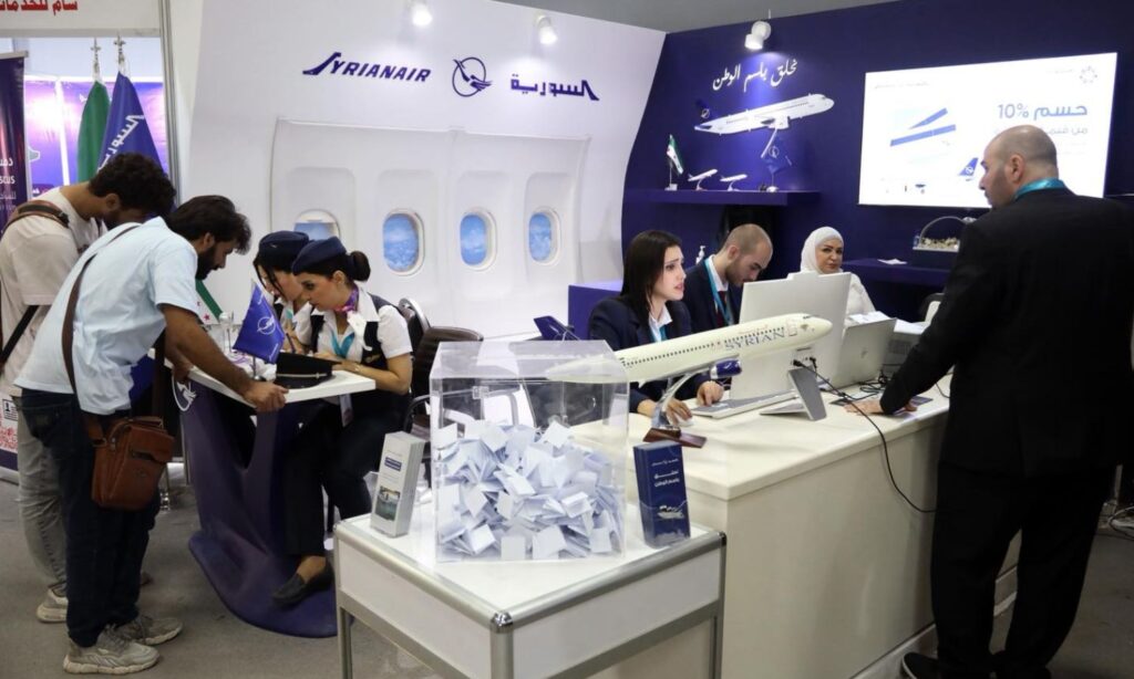 Visitors at the Syrian Airlines pavilion during the Damascus International Fair participate in a draw for free flight tickets – August 31, 2025 (Syrian Airlines/Facebook)