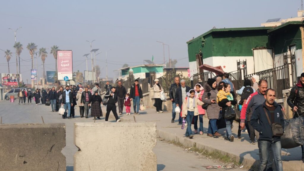 Residents leave Aleppo’s al-Ashrafiya neighborhood via the al-Zohour crossing in the al-Syrian neighborhood, 24 December 2025. (Syrian Interior Ministry/Facebook)