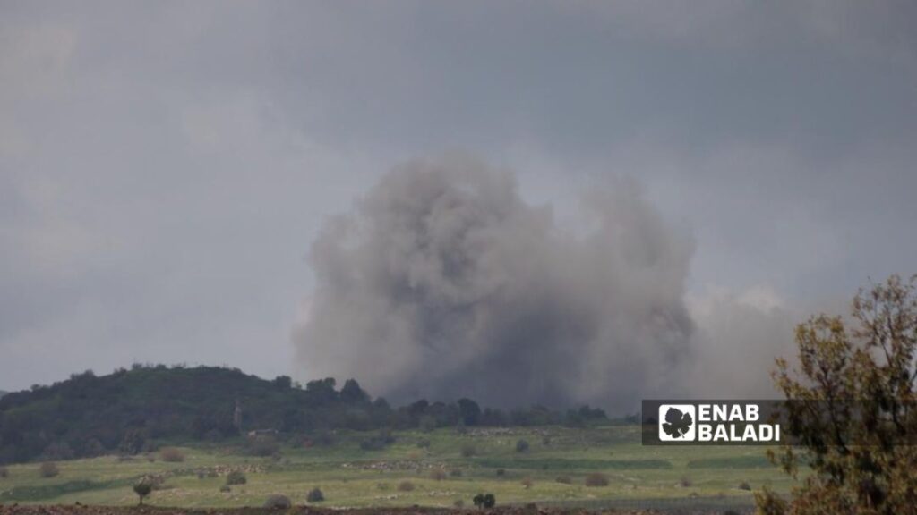 Columns of smoke rise behind the Israeli army’s al-Adnaniyah base after mines were detonated in the area, April 20, 2026. (Enab Baladi/Anwar Asfour)