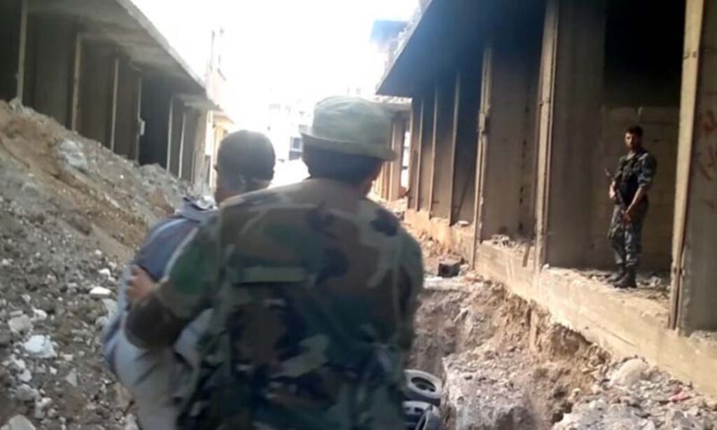A screenshot from the video recording of the Tadamon massacre shows a man being led by Syrian regime intelligence members before he was killed. (The Guardian)