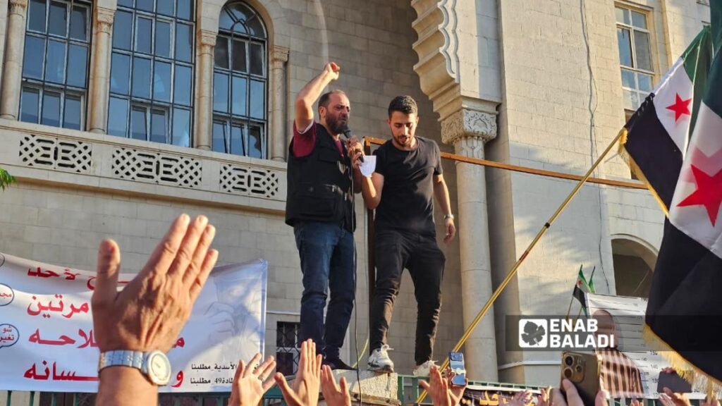 Demonstrators in Damascus demand the activation of Article 49 of the Constitutional Declaration, which criminalizes glorifying or defending the former regime, June 29, 2026. (Enab Baladi/Ahmed Muslimani)