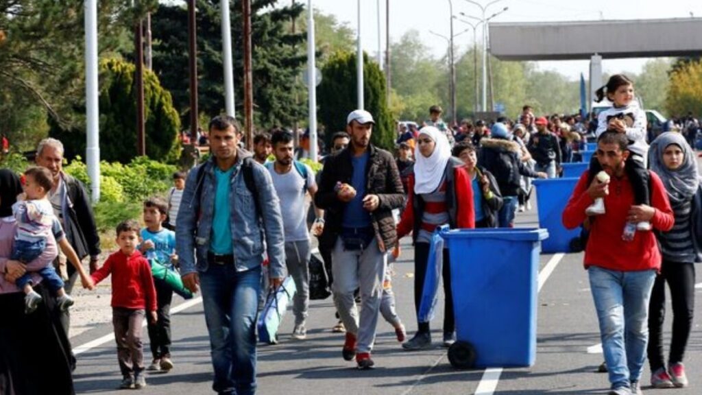 Migrants walk toward the Austrian border from Hungary, July 2, 2025 (Reuters)