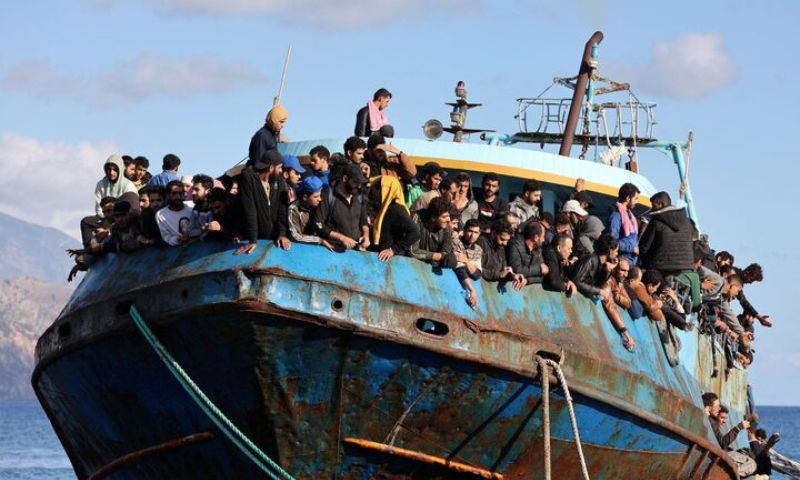 grants sit aboard a fishing boat at a port after being rescued off the island of Crete, Greece, March 13, 2024 (Reuters).
