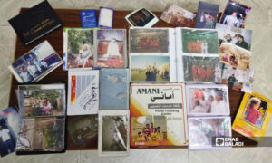 A collection of old family photo albums belonging to residents of Darayya, August 29, 2026. (Enab Baladi, Muhammad Mushmushtin)