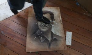 A man steps on a portrait of ousted Syrian President Bashar al-Assad in the al-Malki neighborhood of Damascus, December 8, 2024 (AFP).